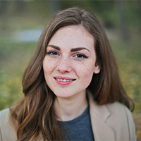 A busy mom showing how satisfied she is with Olympic Pooper Scoopers dog waste removal service that frees her from that poop scooping chore.